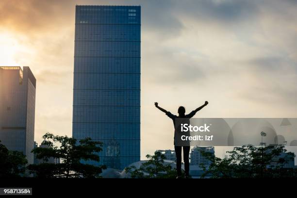 Young Successful Woman Standing With Arms Open In City Stock Photo - Download Image Now