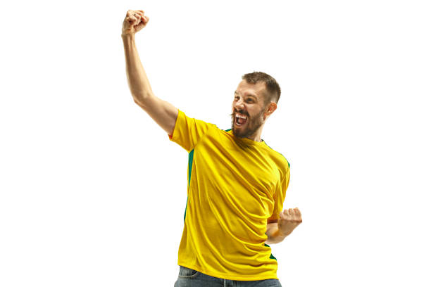 istock Brazilian fan celebrating on white background 958714292