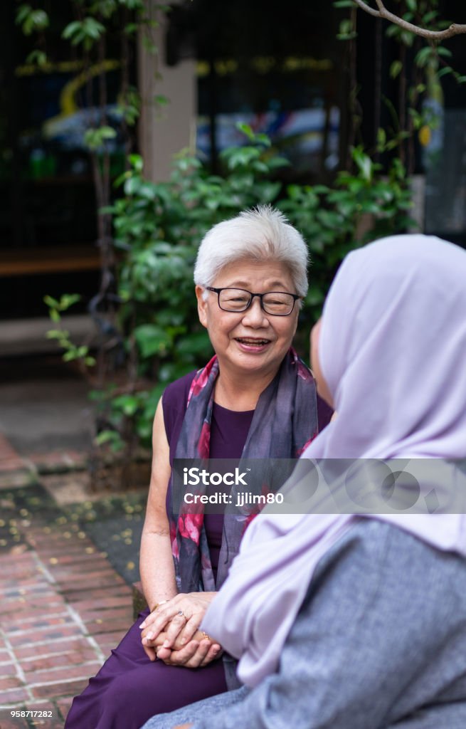 Malaysia People Photo of a modern chinese elder chit chatting to a young malay lady Aunt Stock Photo