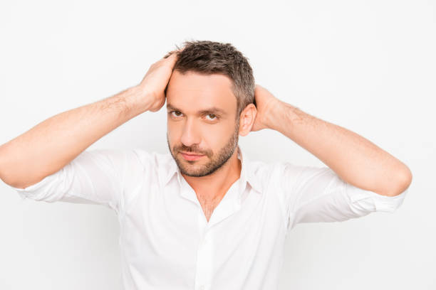istock Attractive man touching his hair on white background 958719580
