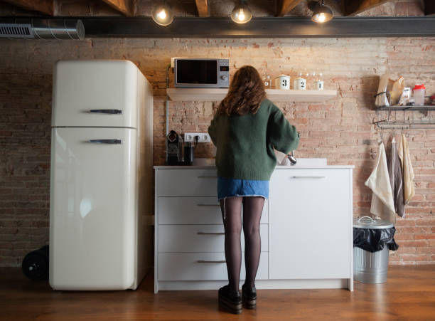istock Beautiful girl cleaning in a modern kitchen 958720174