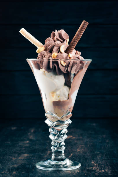 istock Chocolate ice cream with nuts. On a black wooden background. Copy space. 958723654