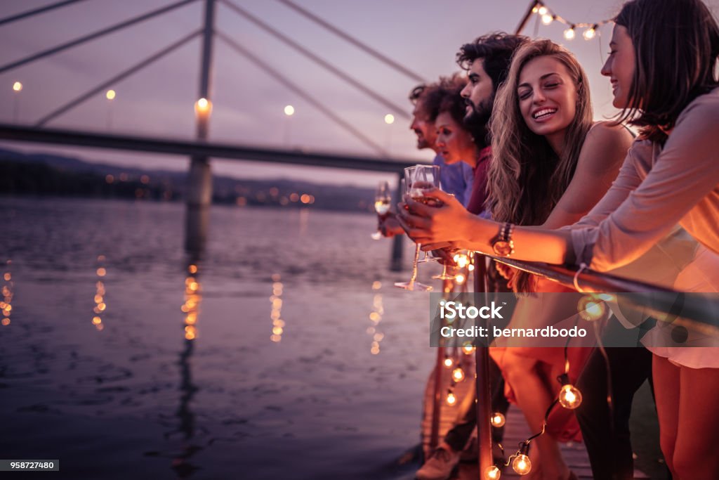 Beautiful day for a cruise Group of friends relaxing on a boat cruise Party - Social Event Stock Photo