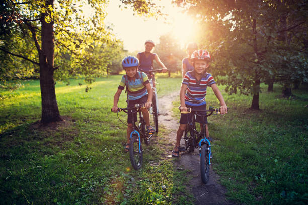 istock Family riding bicycles in park 958727566