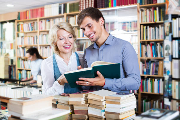 istock Woman and man having books 958731298