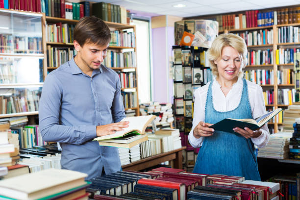 istock Woman and man having books 958732338