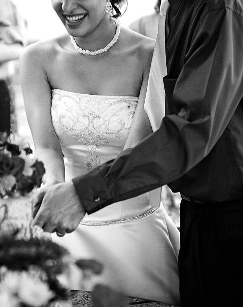 istock Happy young married couple cutting the cake at their wedding 95873401