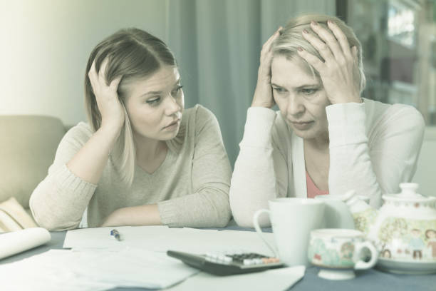 istock mother and her adult daughter with financial problems 958735590