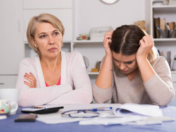 istock mother and her adult daughter with financial problems 958735604