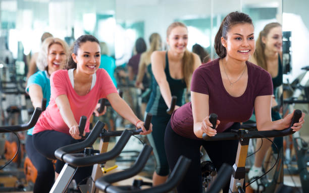 istock Females riding stationary bicycles 958736314