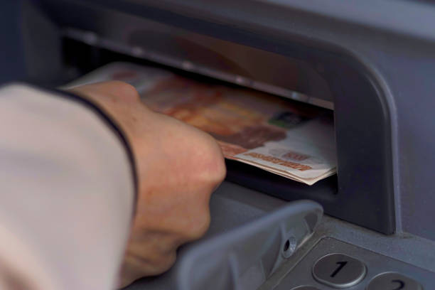 istock The hand takes a bundle of money from the open ATM receiver 958737948