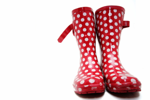 Red wellington boots with white spots on a white background