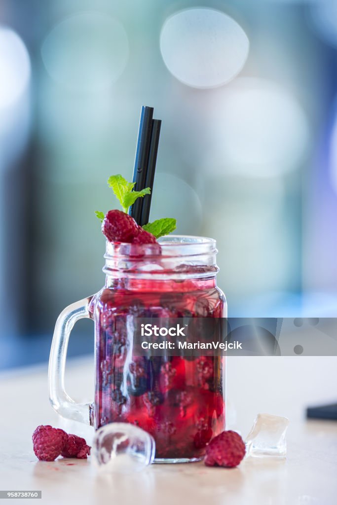 Raspberries non alcoholic lemonade with mint leaves and ice cubes Raspberries non alcoholic lemonade with mint leaves and ice cubes. Bar - Drink Establishment Stock Photo