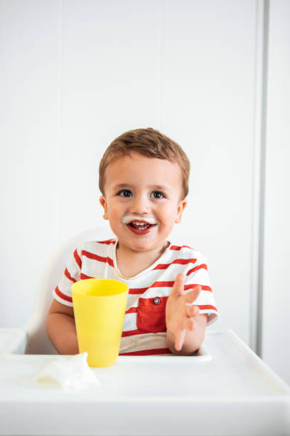 istock Portrait of boy drinking milk on an open cup 958749292