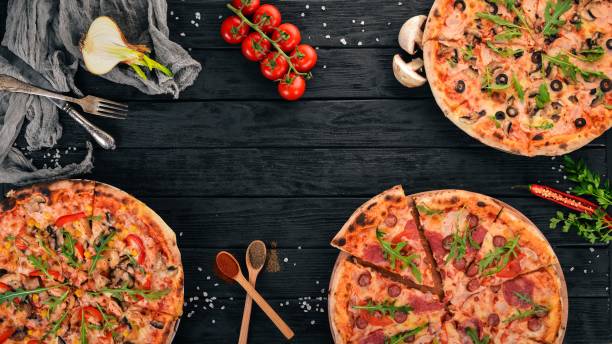 istock Set pizza. Italian cuisine. Top view. On a wooden background. Copy space. 958753880