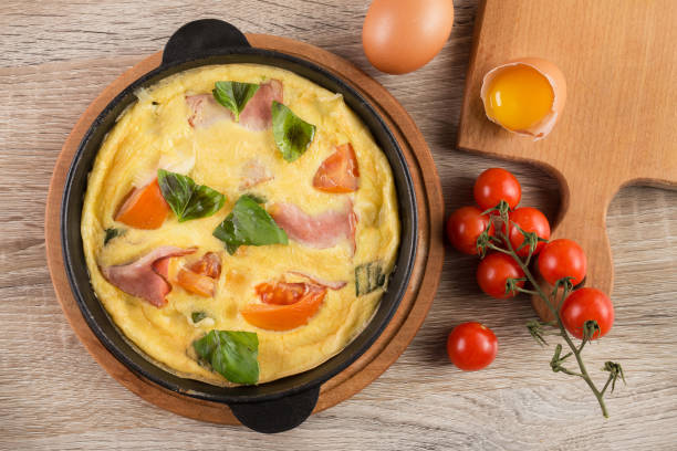 istock Hot omelet with bacon, tomato and basil 958757132