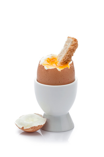 Scrambled egg, poached egg, fried egg, boiled egg on toast on a board