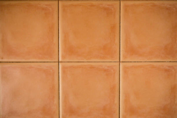sfondo mattoni quadrati arancioni - terracotta foto e immagini stock