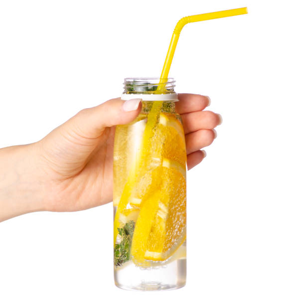 istock Bottle lemonade lemon orange with mint in hand 958765406