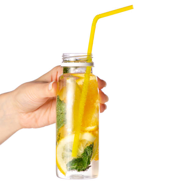 istock Bottle lemonade lemon orange with mint in hand 958765410