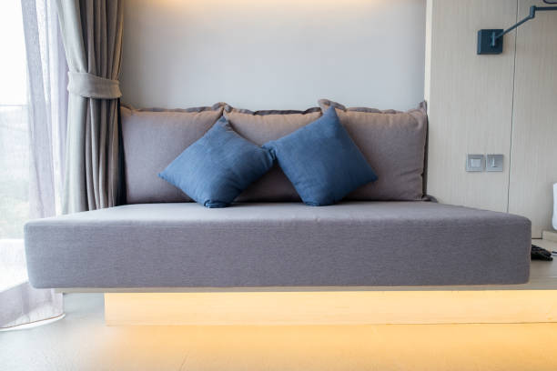 istock Brown sofa with blue pillows in bedroom 958770646