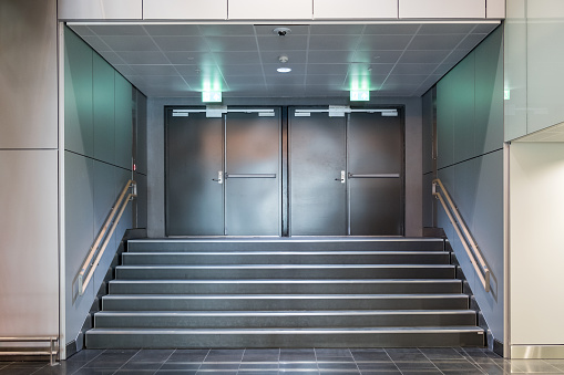 Fire exit metallic doors with staircase and handrails