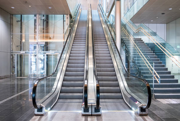 Modern luxury escalators with staircase Modern luxury escalators with staircase at airport Elevators and Escalators stock pictures, royalty-free photos & images