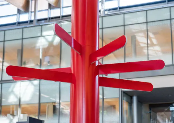 Red round plate wooden guidepost at inside corridor