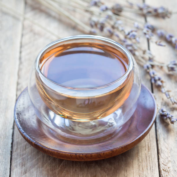 istock Healthy herbal lavender tea in oriental glass cup, square 958777894