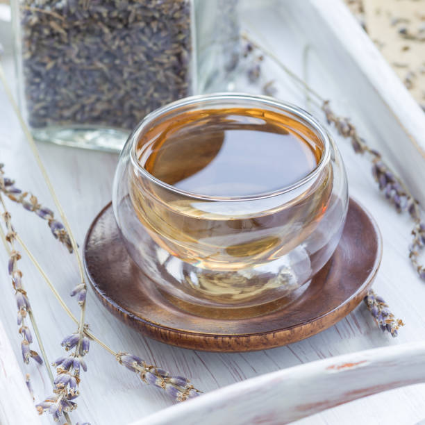 istock Healthy herbal lavender tea in oriental glass cup, square 958777978