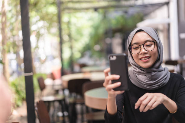 istock Muslim girl checking social media. 958784996
