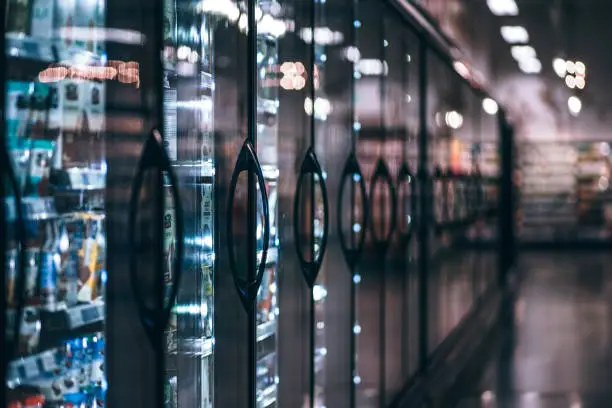 Frozen section, refrigerators with frozen products in a grocery store.