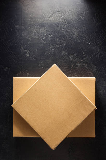 istock cardboard box on wooden shelf 958790754