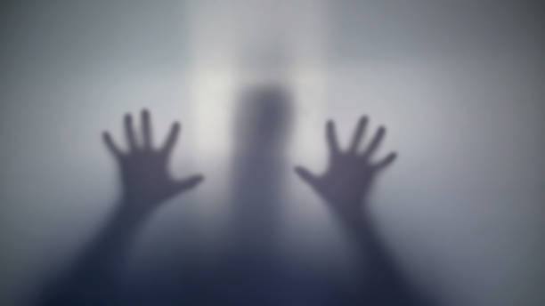 istock Scared male silhouette holding transparent film asking for help strange creature 958794494