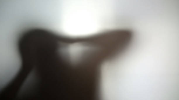 istock Strange dark silhouette holding head in hands, hallucinations, desperate person 958794586
