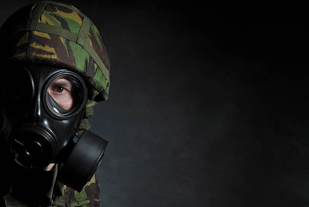 Gas mask on a green camouflage uniform.