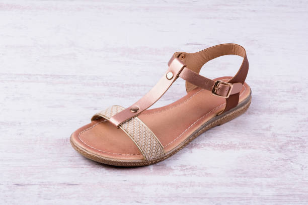 istock Women's sandal on white wooden background. 958800186