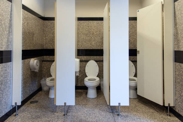 Flush toilet in Public three rooms toilet and open door stock photo