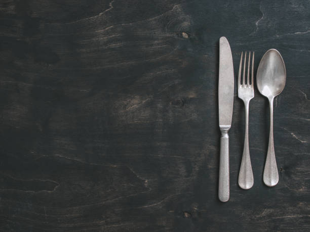 vintage cutlery on dark background, copy space - table knife silverware black fork imagens e fotografias de stock