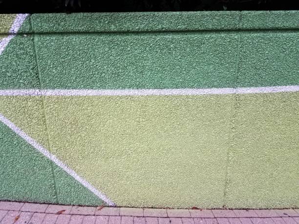 istock green paint on cement wall with white lines 958829292