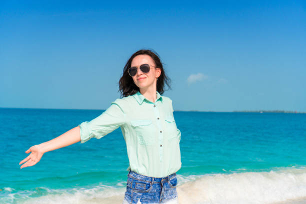 istock Young beautiful woman on tropical beach vacation 958830446