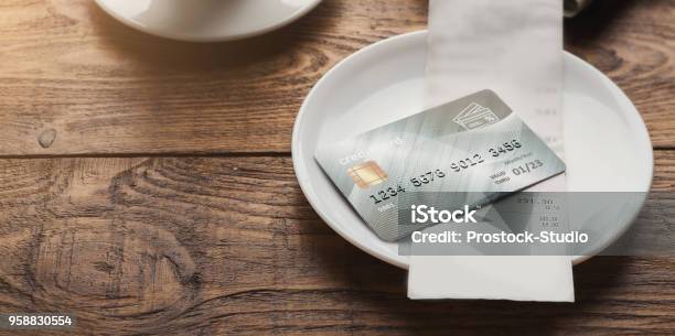 Restaurant Bill And Credit Card On Wooden Table Stock Photo - Download Image Now - Credit Card, Restaurant, Financial Bill