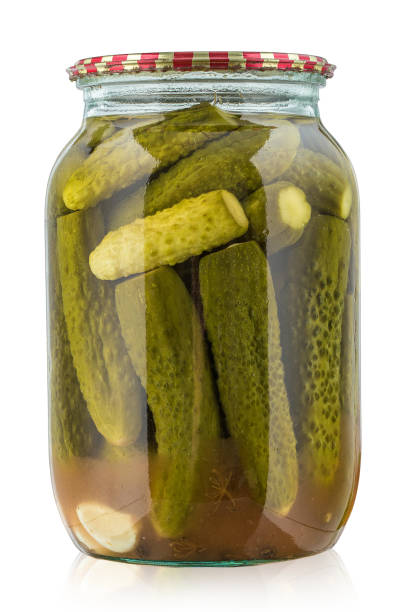 istock Canned cucumbers in jar isolated on white background. 958831802
