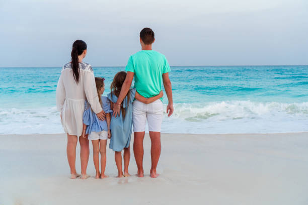 istock Happy beautiful family on white beach 958834790