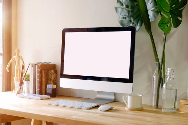 istock Mock up workspace wooden table with Blank screen computer, dummy, houseplant. desk workspace with isolate  screen for graphic display montage. 958835330