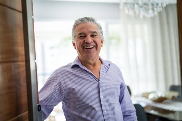 Mature Man Welcoming Home Opening His Front Door