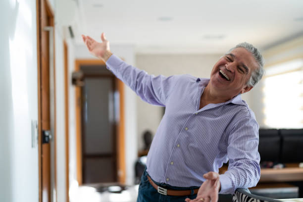 istock Mature Man Dancing and Welcoming Home Opening His Front Door 958836320