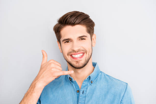 istock Playful smiling young guy asking to call him 958842438