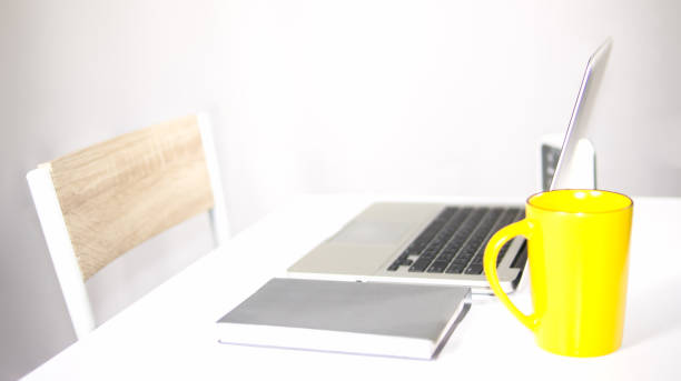 istock Work desk have laptop, notebook, clock and cup of water on gray background 958847276