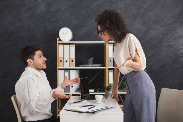 istock Couple of young colleagues arguing at office 958847620